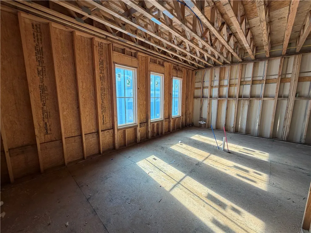 Framed interior space with abundant natural light awaits personalized finishing touches.