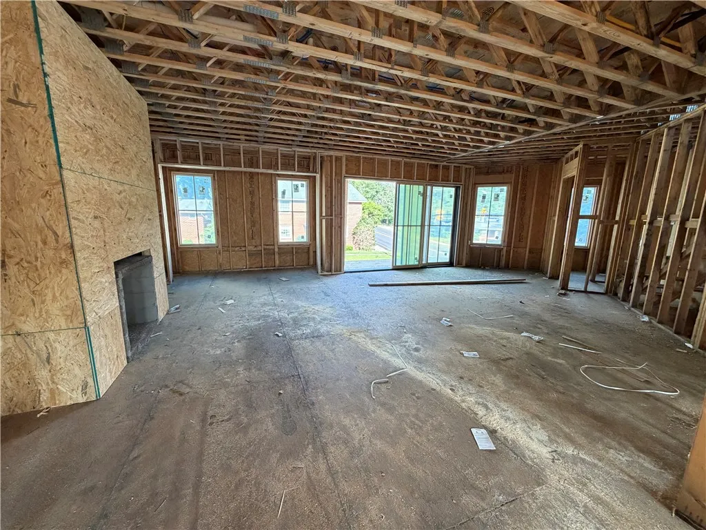 Framed walls and ceiling beams await your vision for a new construction living space.