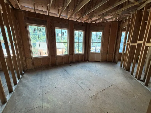 Framed-out walls and multiple windows promise abundant natural light and an open layout in this future living space.