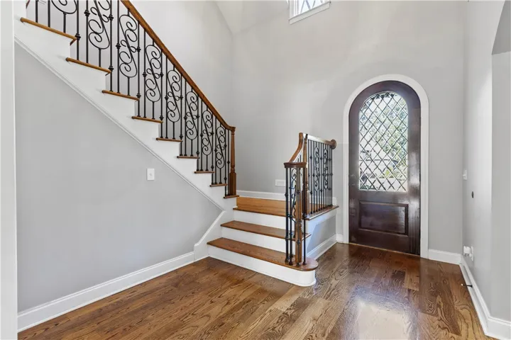 Double height foyer with custom front wood door