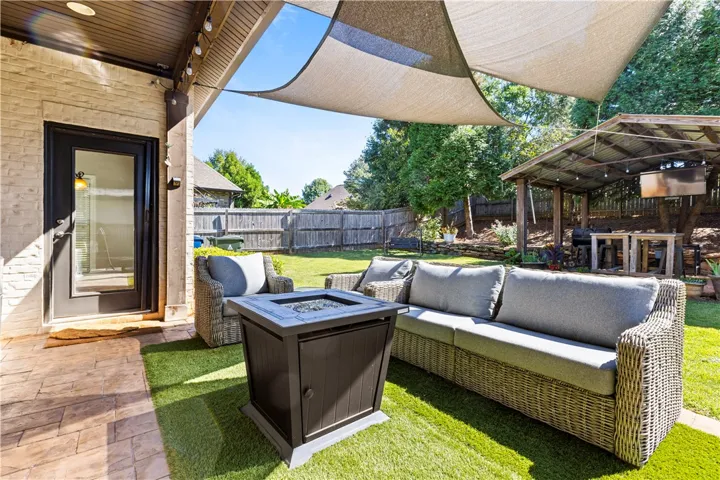 covered rear patio with firepit