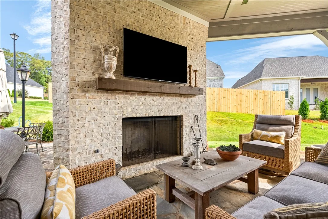 outdoor wood burning fireplace on covered porch