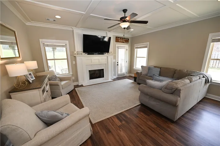Living room with coffered ceilings, recessed lighting gas fireplace.