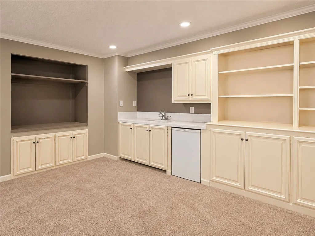 A versatile space features custom built-ins, ample storage, and a convenient wet bar perfect for entertaining.
