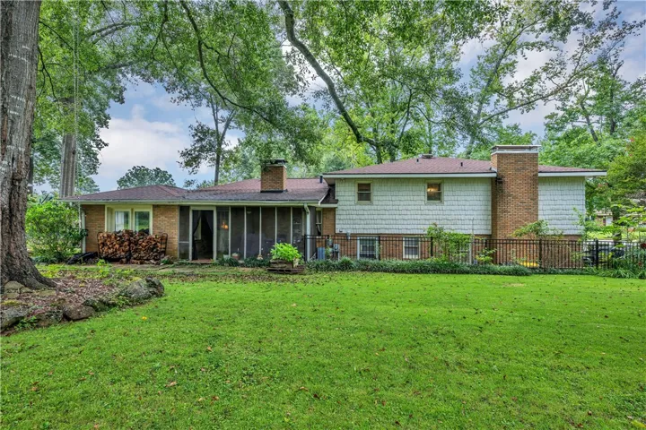 A screened porch and large backyard offer abundant space for outdoor relaxation and entertaining.