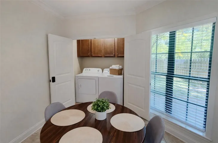 This cozy space features a practical laundry area, making everyday chores simple and convenient.
