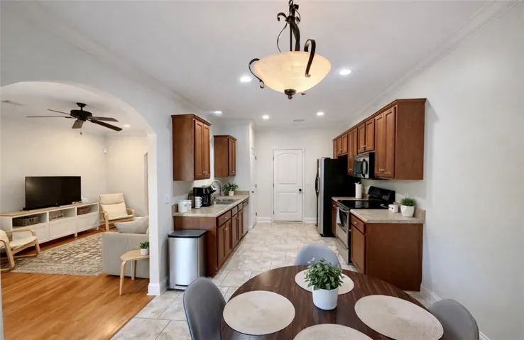 This open concept kitchen and living area features warm wood cabinets and modern appliances.