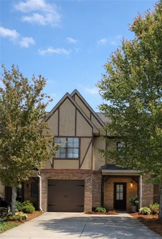 This charming home showcases a unique architectural style with a welcoming entryway and mature trees.