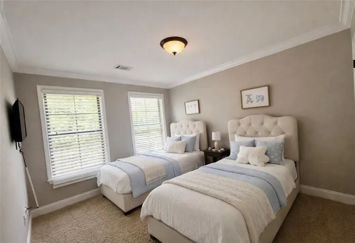 This inviting bedroom features natural light and soft finishes, perfect for serene living.