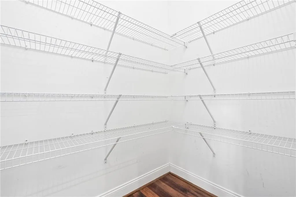 An organized closet offers abundant storage with multiple wire shelving units.