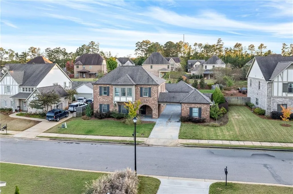 A classic brick exterior graces this two-story residence with an attached garage.