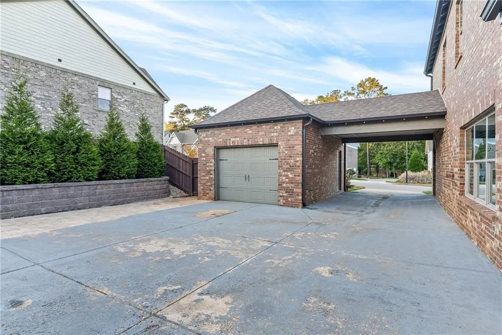 A detached garage with a covered walkway provides convenient and sheltered access to the residence.