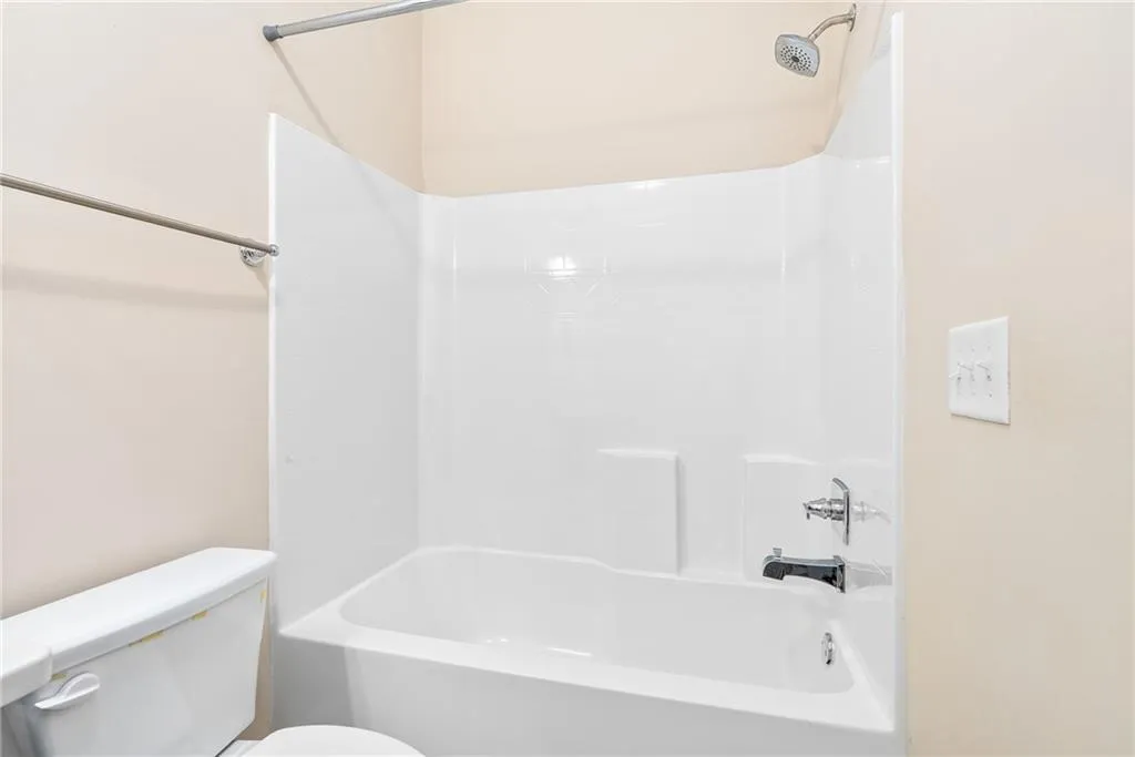 A well-maintained bathroom offering a standard shower-tub combination for daily convenience.