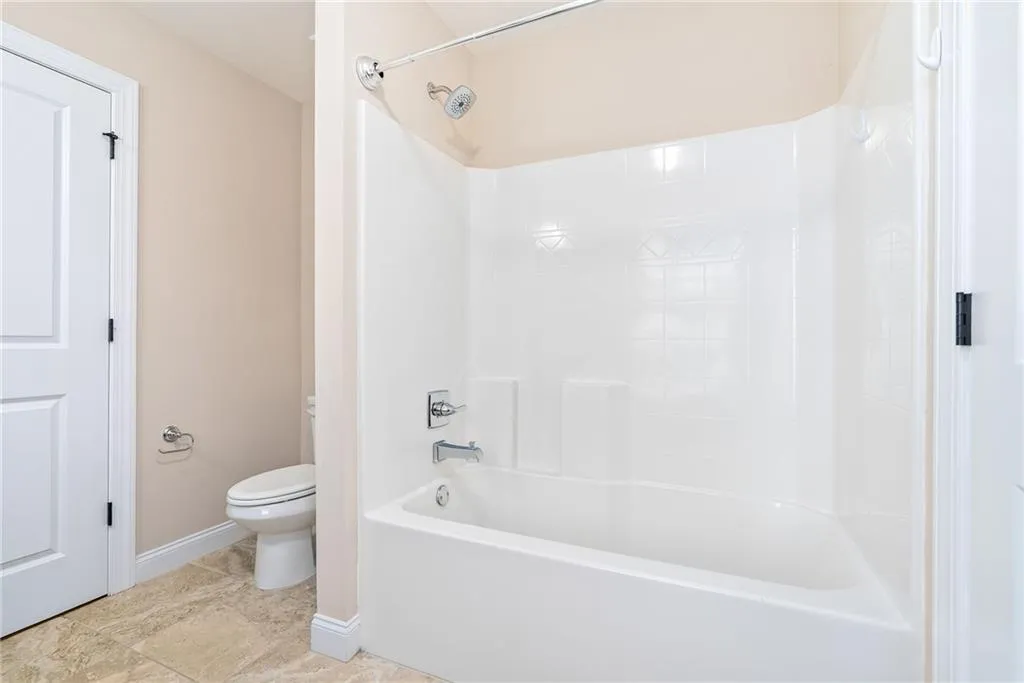 A well-appointed bathroom features an integrated shower and tub unit.
