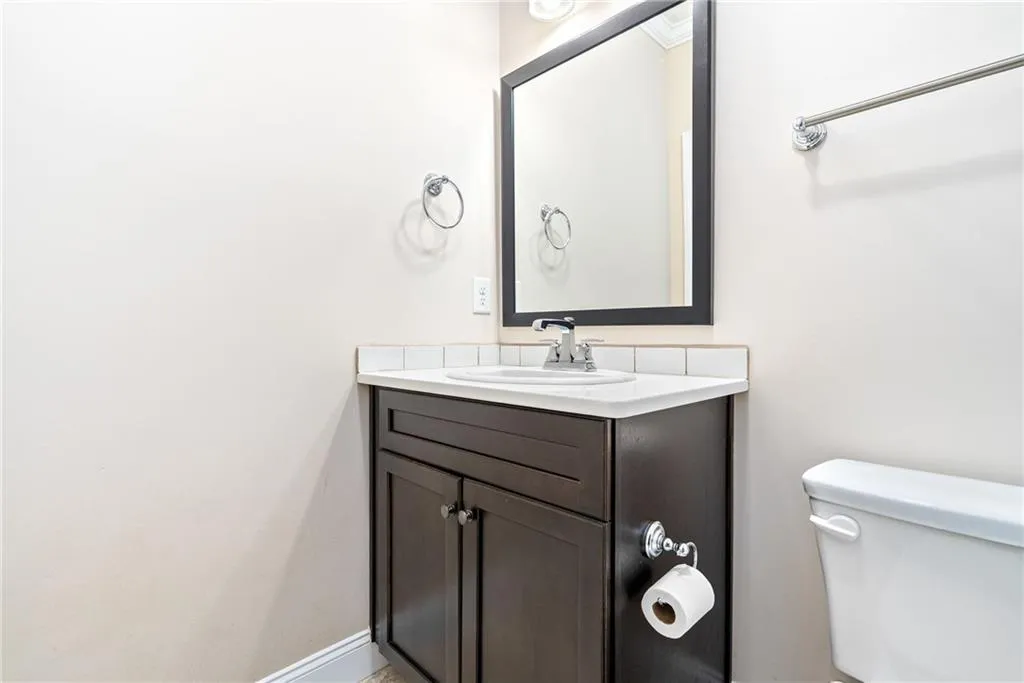 Functional vanity with sleek dark cabinetry and a crisp white countertop.