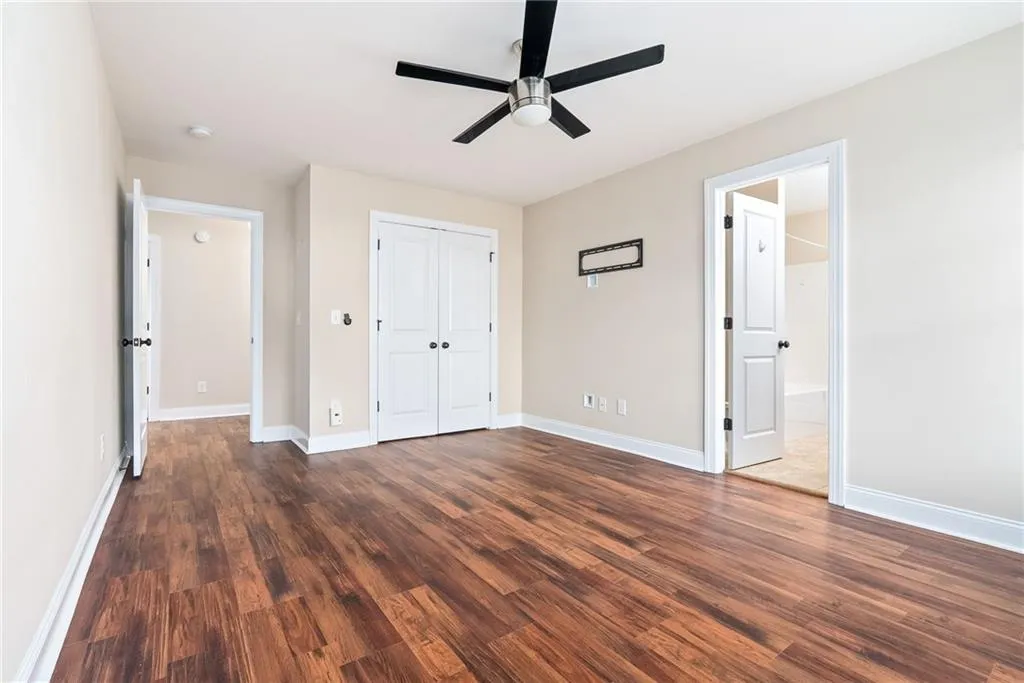 Rich hardwood-style flooring extends across this spacious room, ready for personalization.
