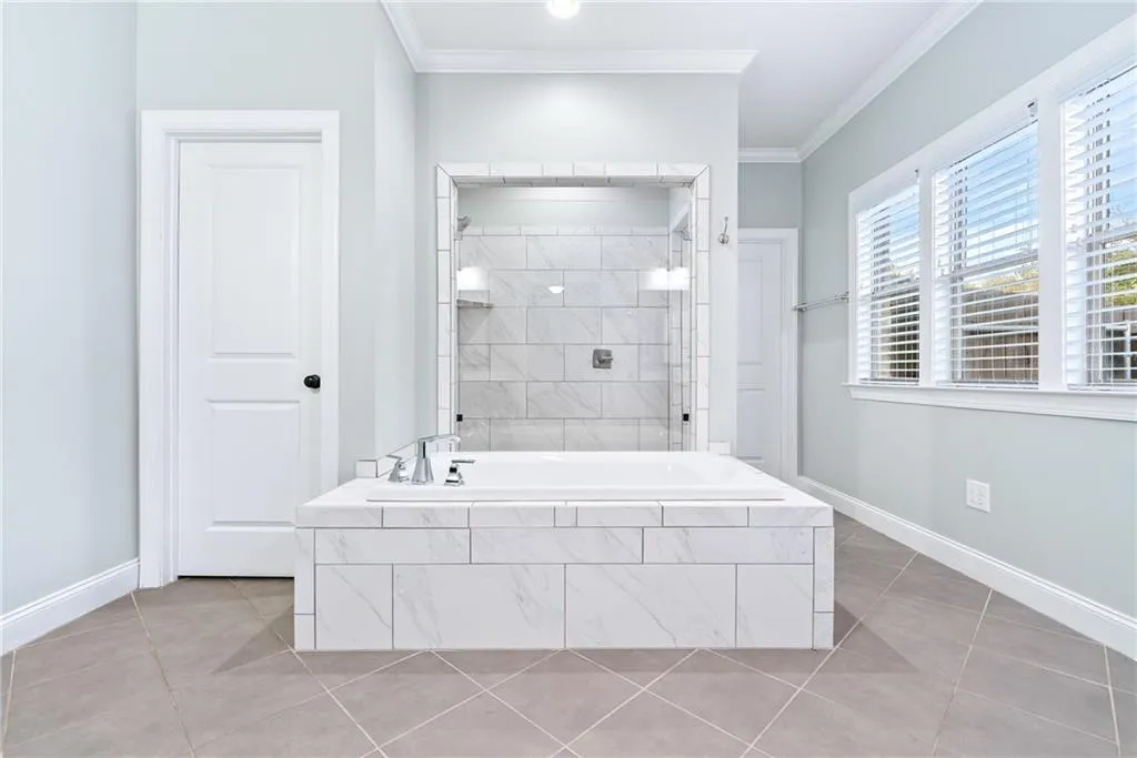 Luxurious bathroom with a spacious soaking tub and an elegant tiled shower.