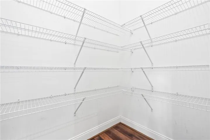 An organized closet offers abundant storage with multiple wire shelving units.