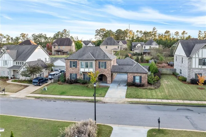 A classic brick exterior graces this two-story residence with an attached garage.