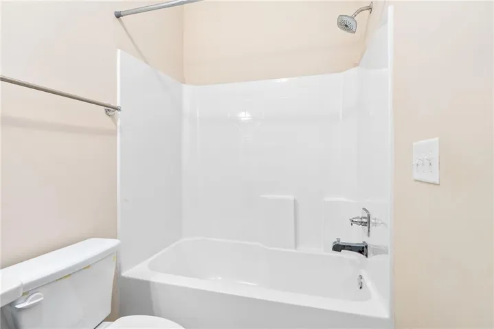 A well-maintained bathroom offering a standard shower-tub combination for daily convenience.