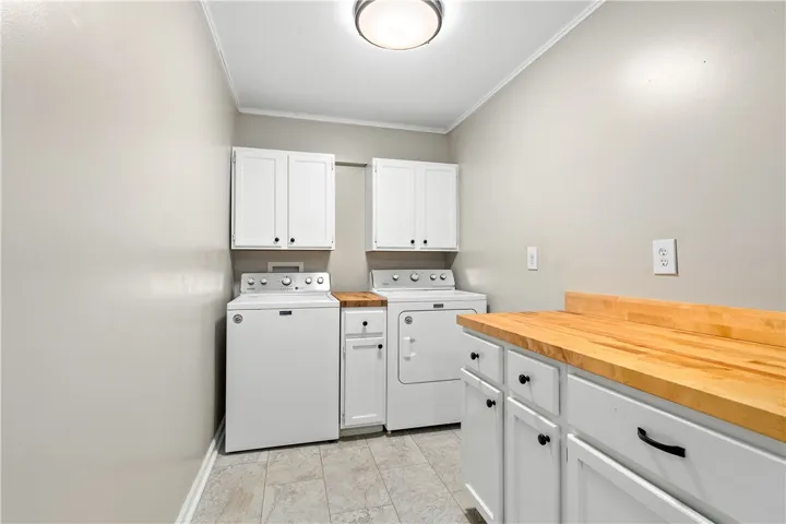 Laundry room. WASHER and DRYER REMAIN!!! Look at all that storage!! Plenty of room for folding and organizing and could be pantry use as well