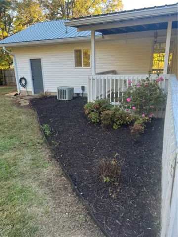 Rear of house has a metal door storage area with a lock
