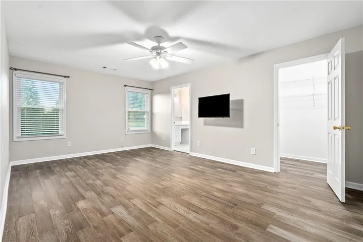 Apartment Living/bedroom space with huge walk-in closet. LVP flooring. Has it's own separate entry and exit and a private covered porch.