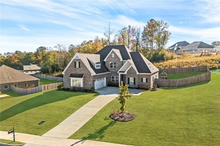 This classic brick residence features a spacious driveway and well-maintained lawn.
