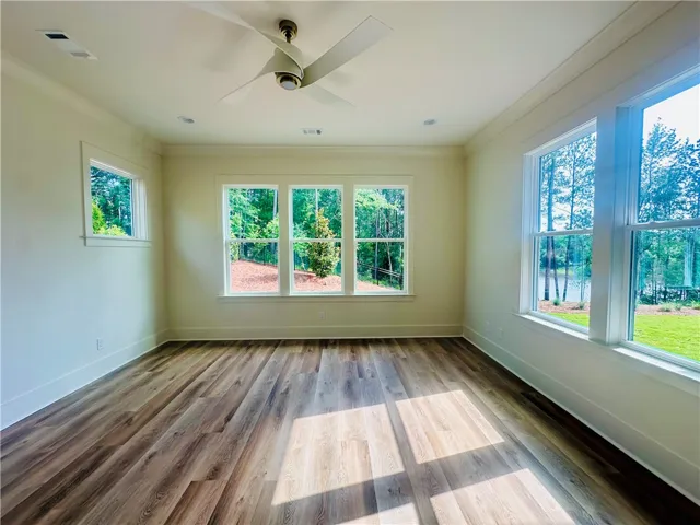 Luminous interior space boasts rich hardwood flooring and sweeping nature views.