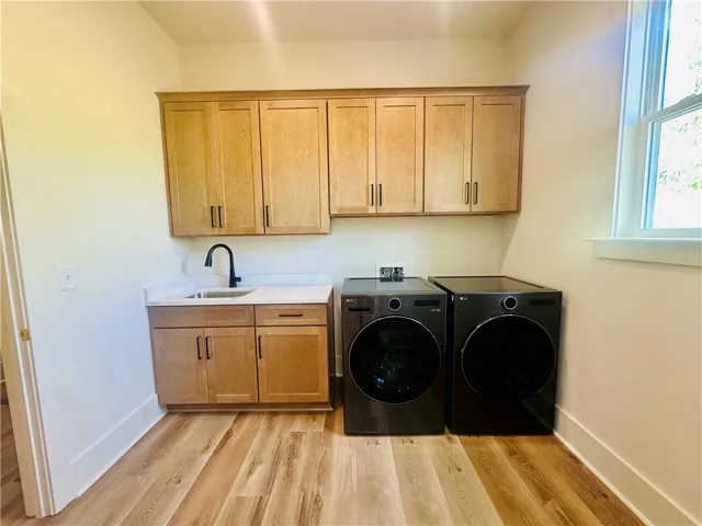 Ample storage and modern appliances elevate this functional laundry space.