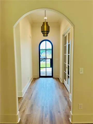 An inviting arched entryway with durable flooring awaits at this home's entrance.