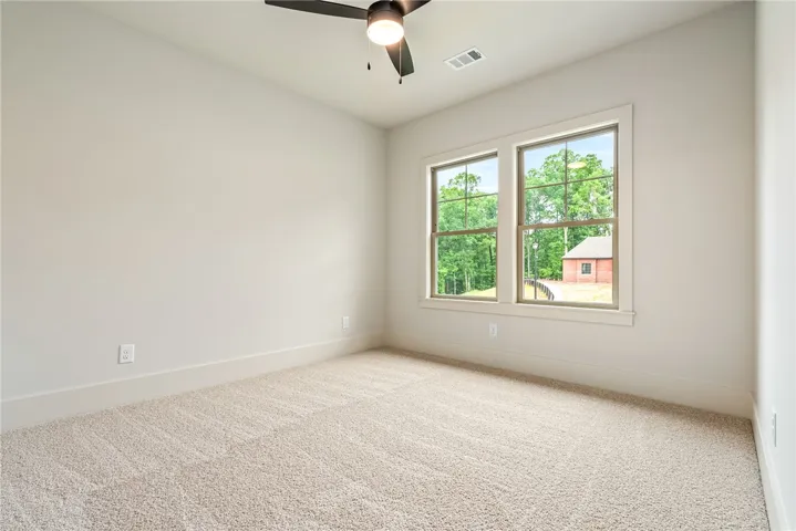 This bright bedroom offers tranquil views, creating a serene and private sanctuary.