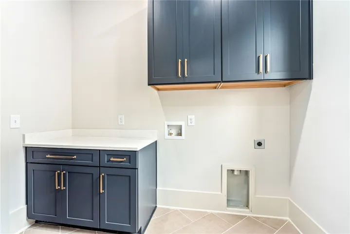 This dedicated space offers practical convenience with essential hookups and elegant cabinetry.