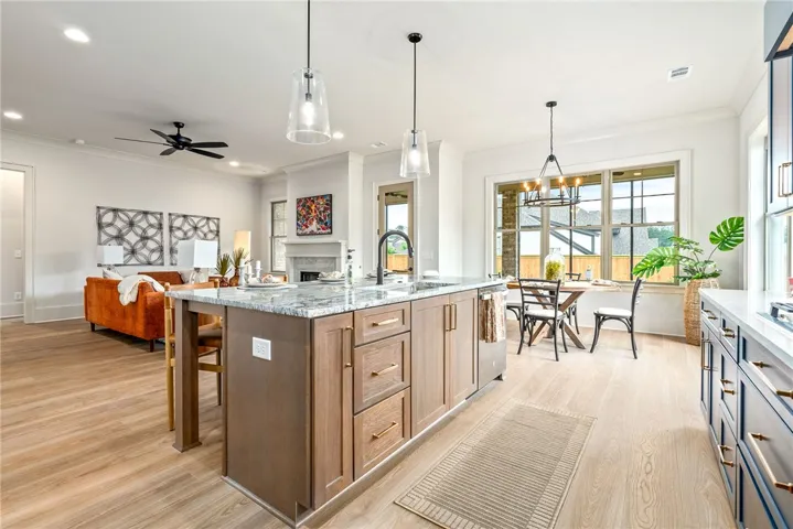 This bright, open-concept living space features a beautiful kitchen island, perfect for entertaining.