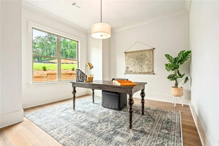 This bright and airy study offers a serene workspace with abundant natural light.