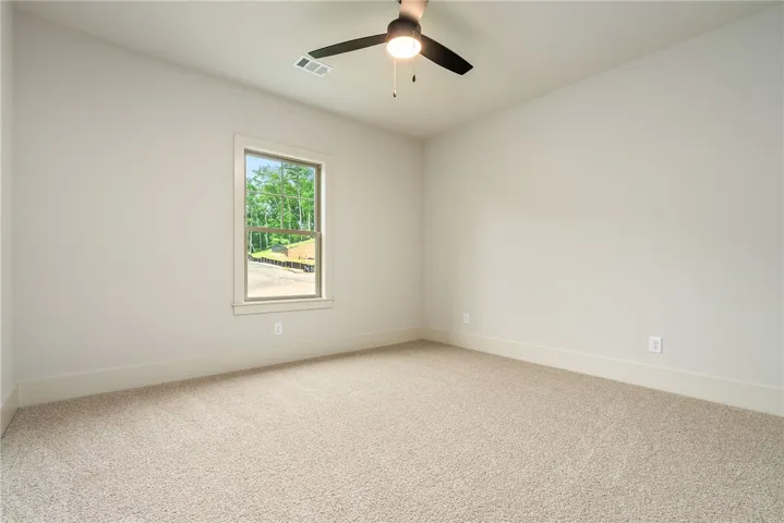 This airy bedroom offers a tranquil retreat with ample natural light.