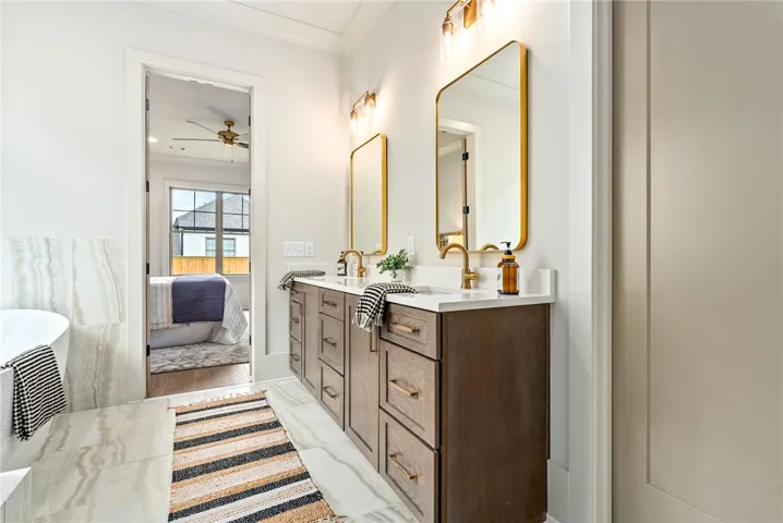 This spacious bathroom offers elegant finishes and seamless access to a comfortable adjacent bedroom.