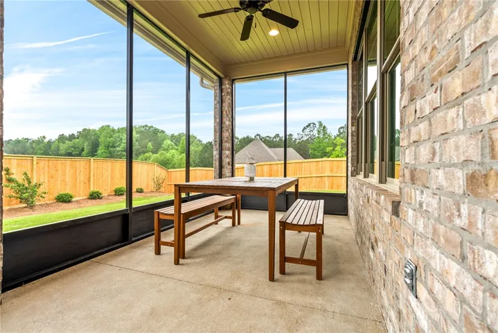 Enjoy outdoor living on this screened porch, perfect for relaxation and entertaining.