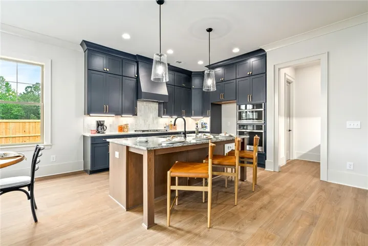 This kitchen features a central island, recessed lighting, and ample cabinet space.