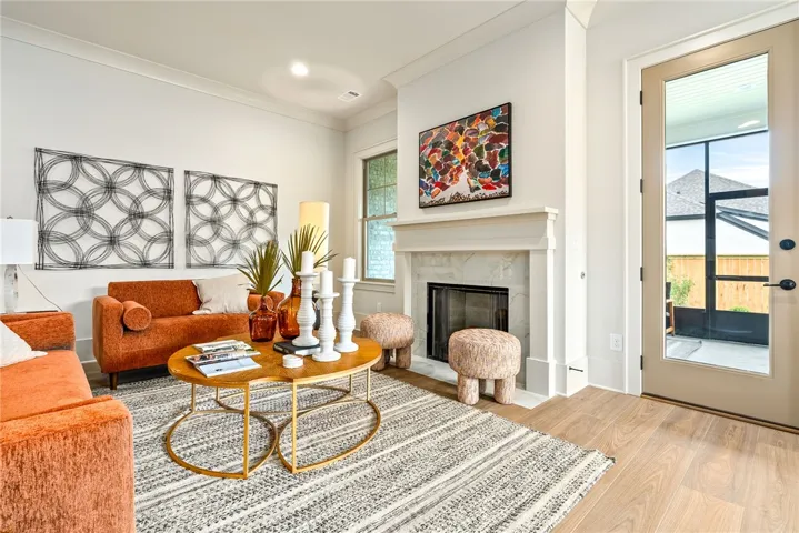 This inviting living room features a gas logs fireplace and offers direct access to the outdoors.