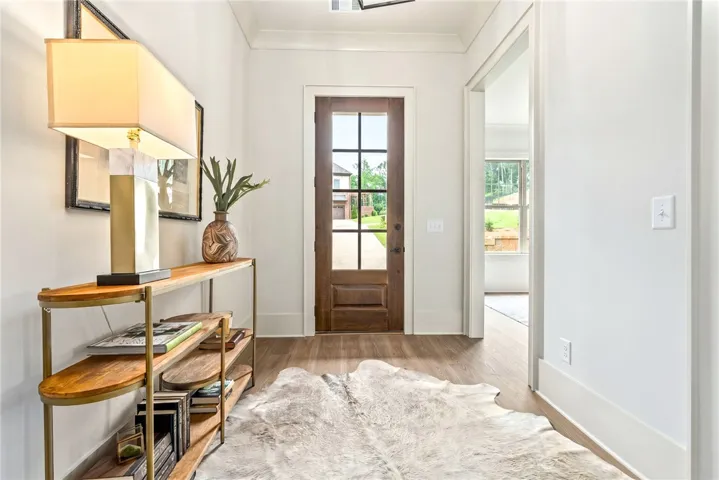 Step inside this inviting entry with warm wood flooring and abundant natural light.