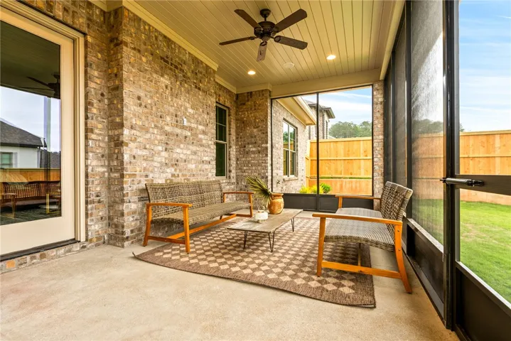 Relax and unwind in this inviting screened-in porch, offering comfort and outdoor living.