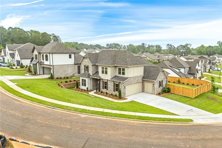 This spacious corner lot home features a classic brick and Hardie exterior with side entry garage.