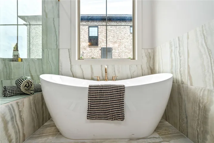 This serene bathroom offers a luxurious soaking tub, perfect for unwinding in a private retreat.