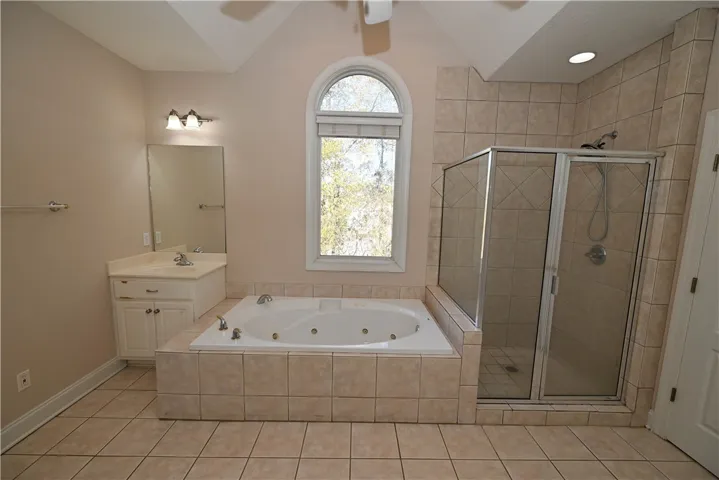 Fitted with a tiled shower and jetted tub.