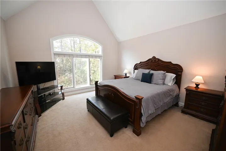 Grand master bedroom with stunning windows.