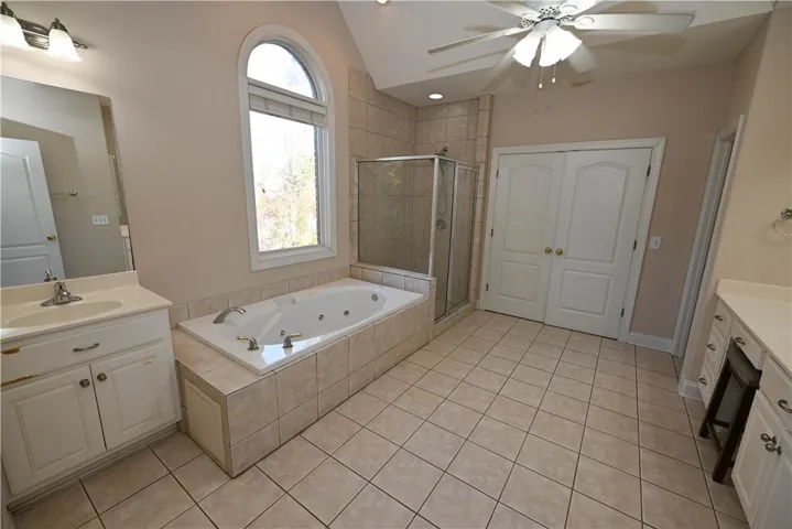 Large primary bathroom filled with light.