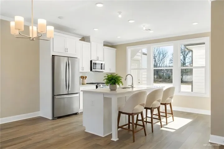 This bright kitchen features stainless steel appliances and an inviting island, perfect for casual dining.