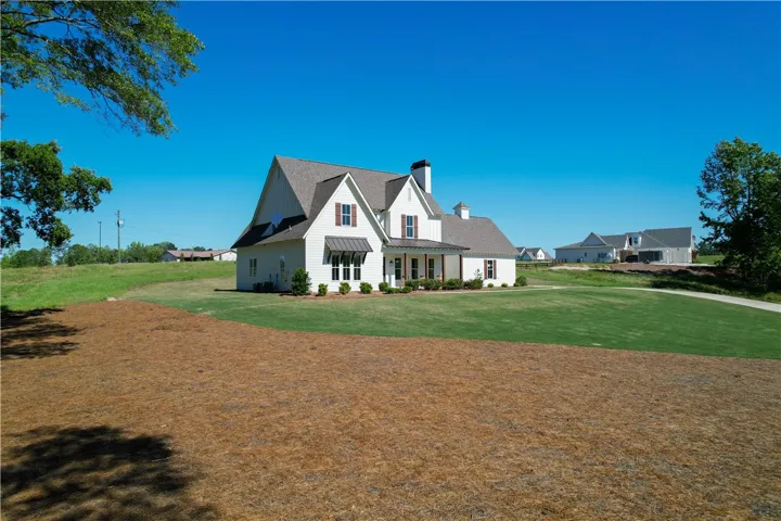 This captivating residence features a classic exterior and a spacious yard, perfect for outdoor enjoyment.