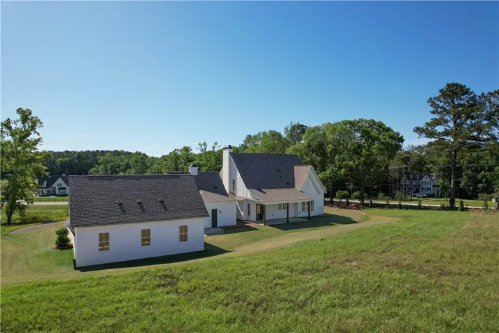 This spacious property offers a serene rural setting with expansive green grounds.